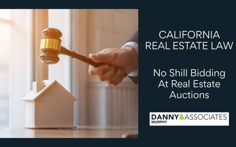 hand holding gavel above a small house