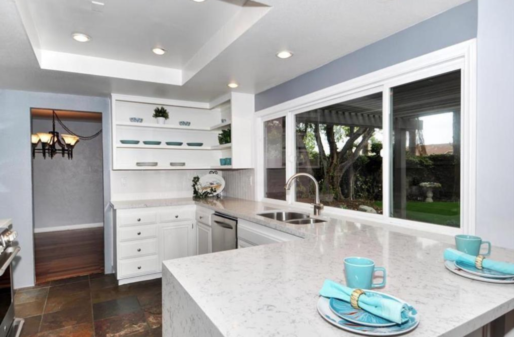 This beautiful property in Huntington Beach has been upgraded, has an open floor plan, and with custom wood windows and doors on both levels it is certainly unique! 