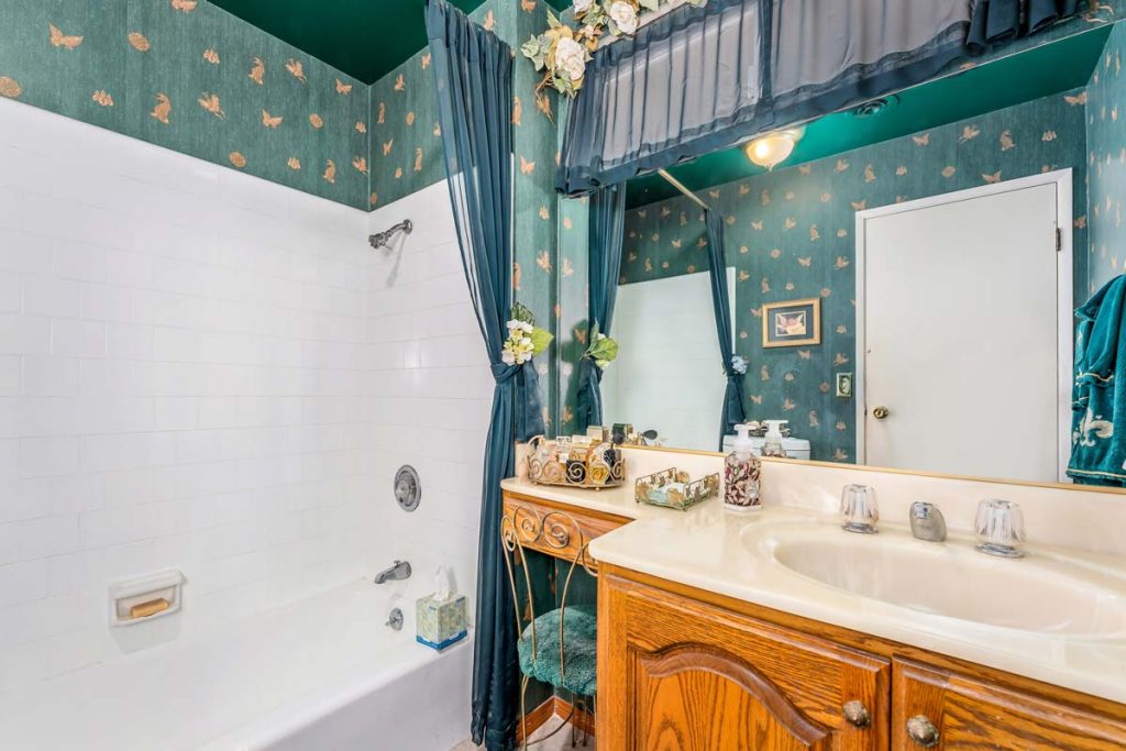 bathroom with green wall paper