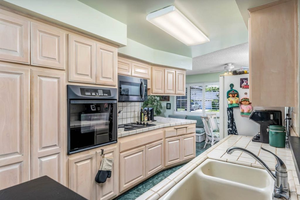 kitchen showing oven, stove, microwave and sink