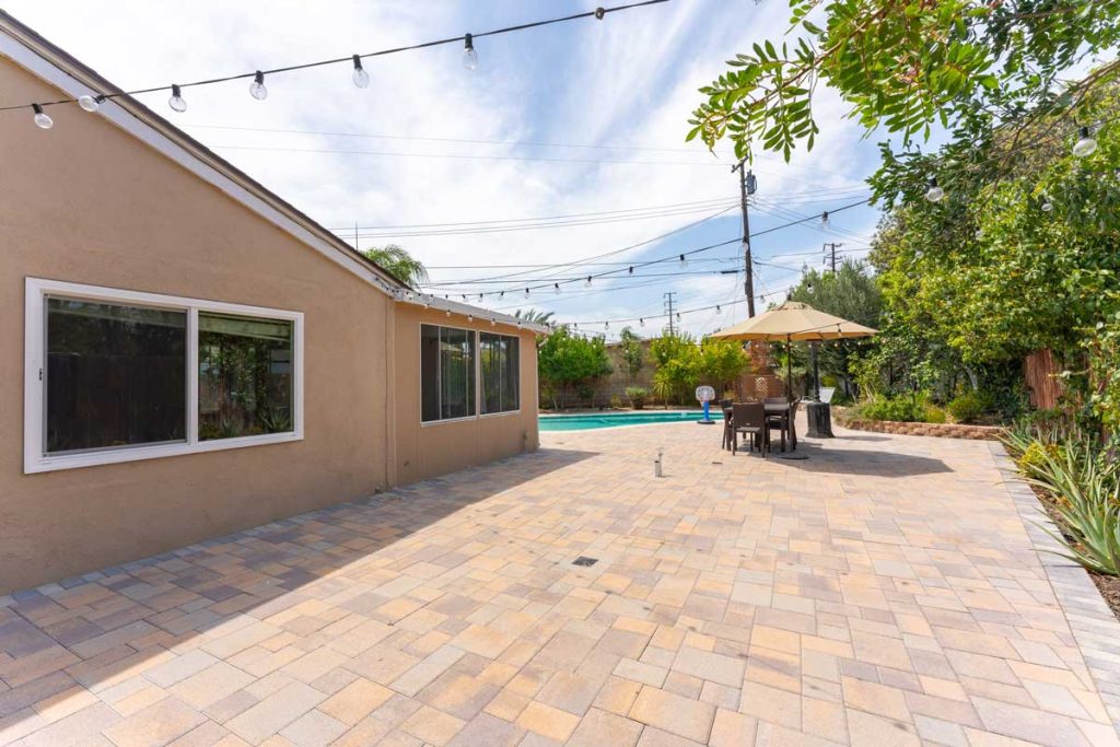 tiled backyard with lights strung above