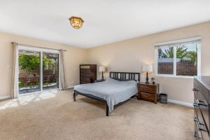 master bedroom with bed and sliding door leading to backyard