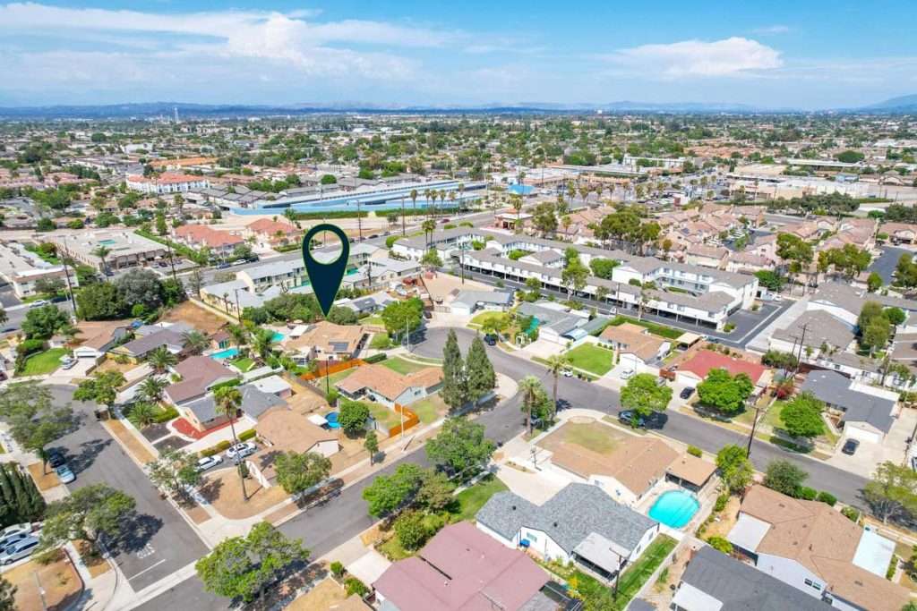 aerial view of featured home with arrow point to house