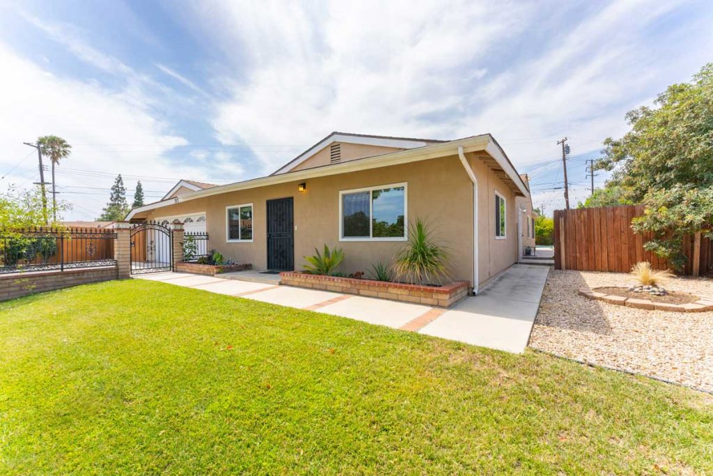 front view of featured home with large grassy area