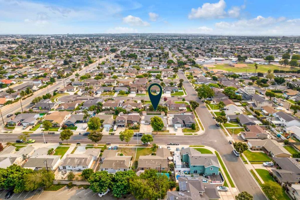 aerial view of neighborhood with arrow pointing to house
