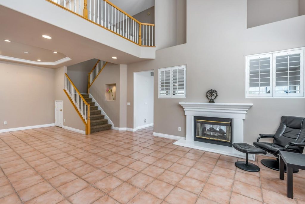 downstairs living room with fireplace and staircase