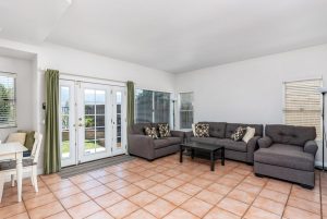 family room with couch and doors leading to backyard