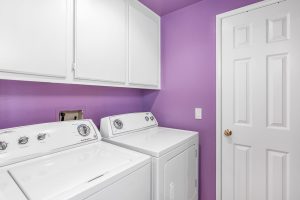 laundry room with purple walls