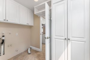 empty laundry room with cabinets and open door
