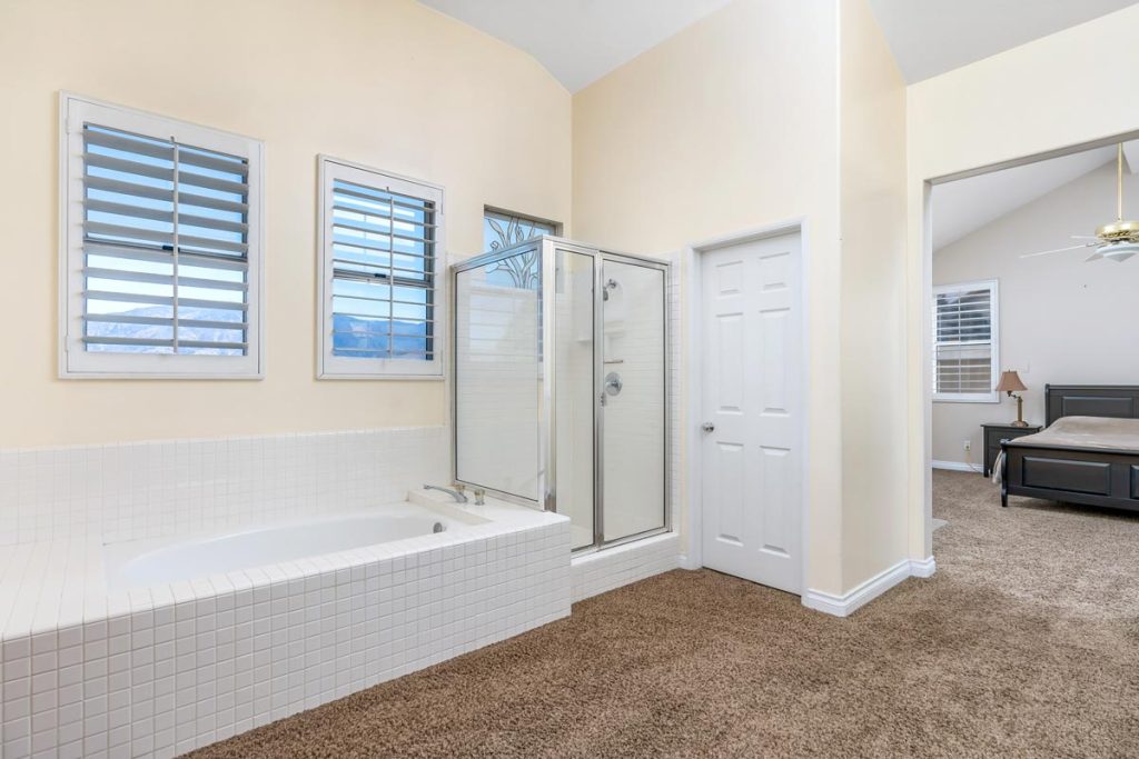 master bathroom with tub and walk in shower