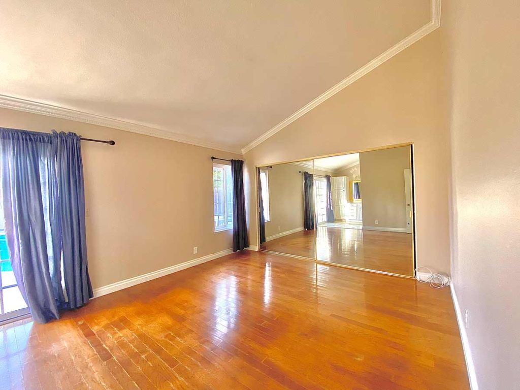 empty master bedroom with vaulted ceilings