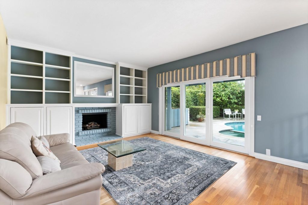 living room with fireplace and sliding door to backyard