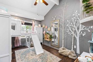 child's bedroom with white trees and loft bed