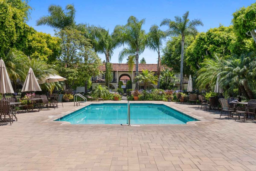 community pool with palm trees surrounding at 3008 Club House Circle, Costa Mesa