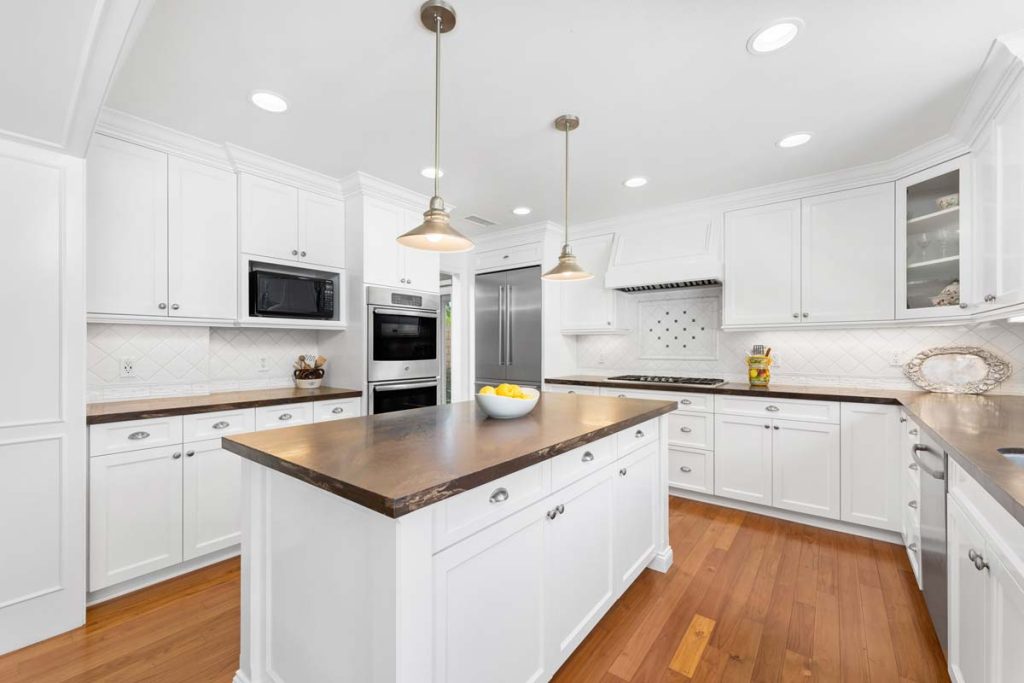 white kitchen with leather granite counters and large island