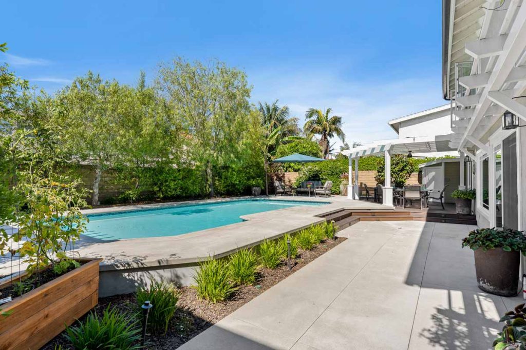 pool in backyard with lush vegetation