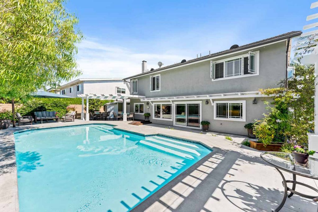 crystal clear pool with house in background