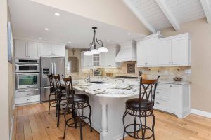 large kitchen island with marble and barstools at 8551 Palermo Drive