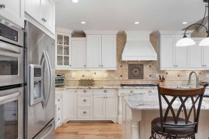 upgraded white kitchen with stone countertops