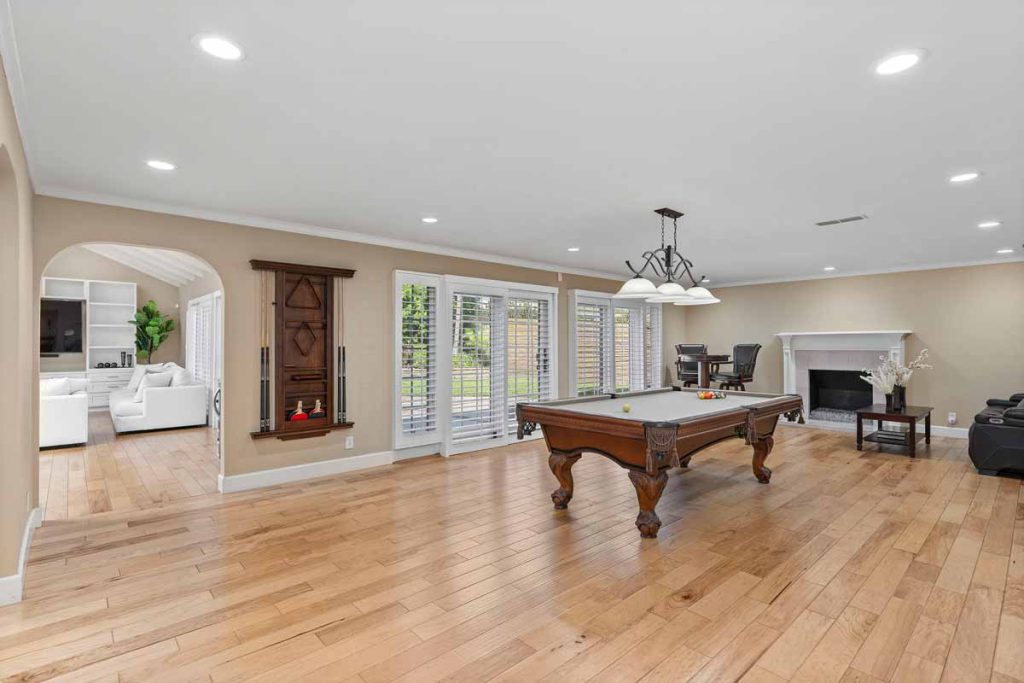 large living space down stairs with pool table and pub table