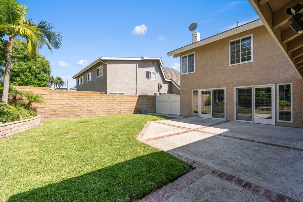 backyard with grass and concrete