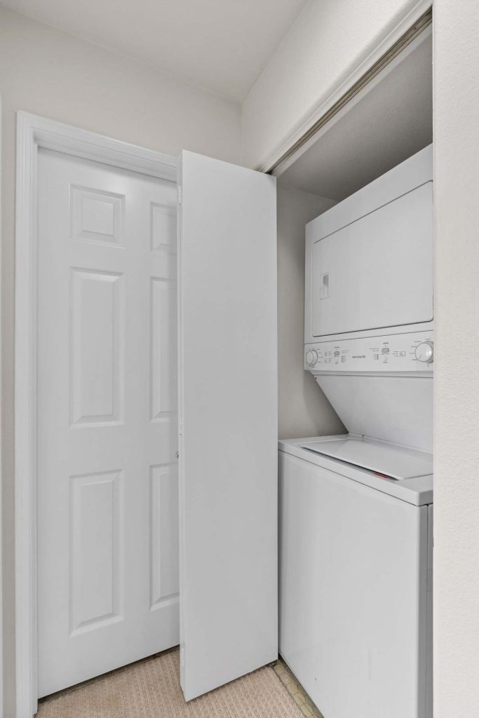 stacked washer and dryer in closet