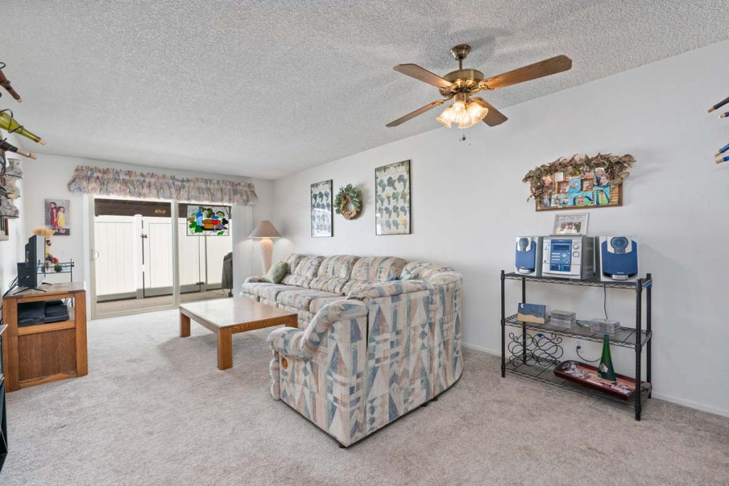 living space with couch, table and ceiling fan