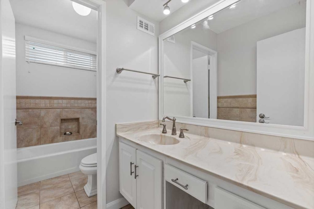 bathroom with sink, toilet, and shower bath combo