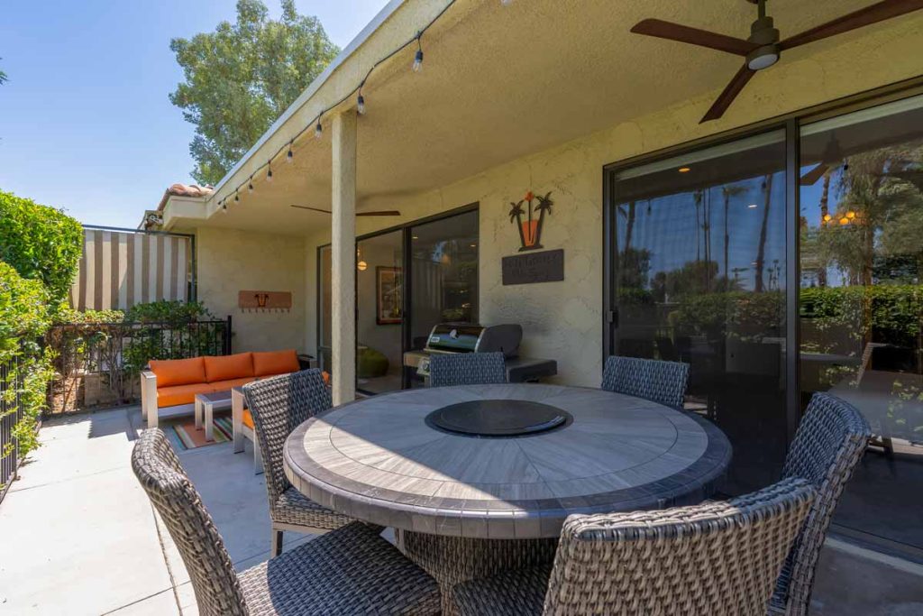 back patio with fire table and chairs at 2478 Oakcrest Dr, Palm Springs