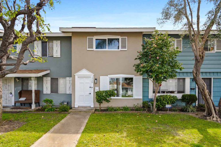 tan exterior of home with white door and trim