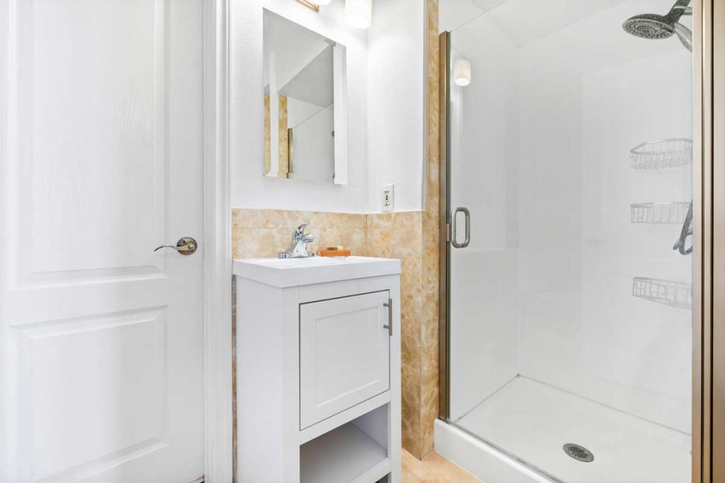 ensuite bathroom with single vanity and walk in shower