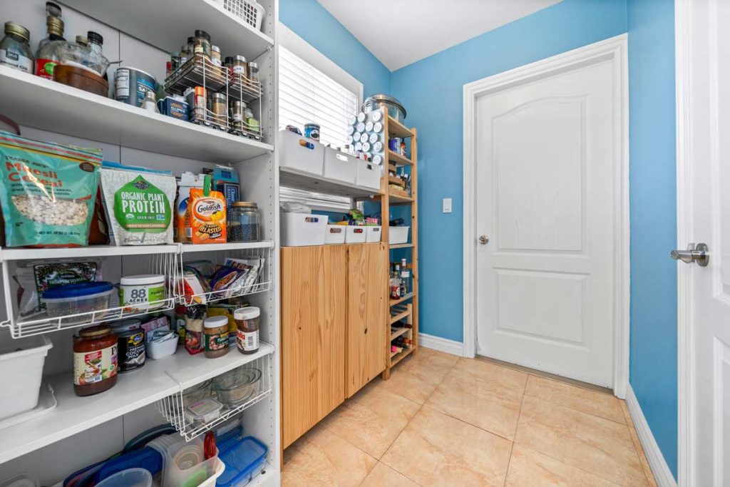 large pantry with door leading to garage