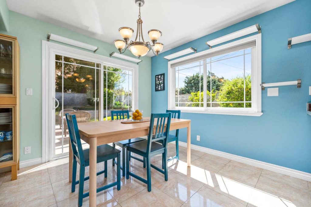 dining space off kitchen with sliding glass doors leading to backyard