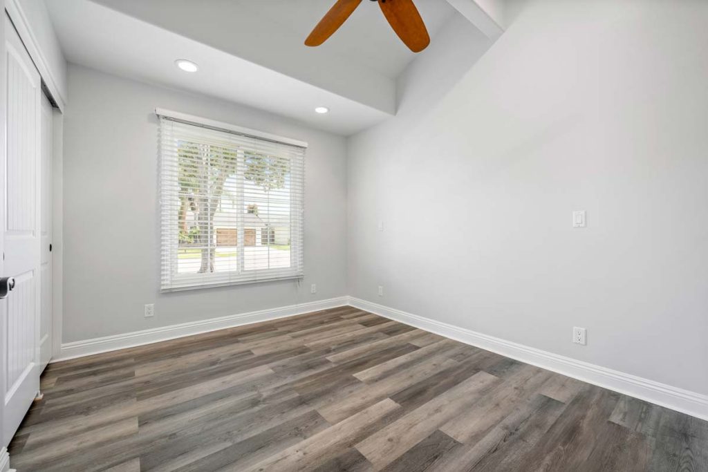 gray toned flooring with white walls and window