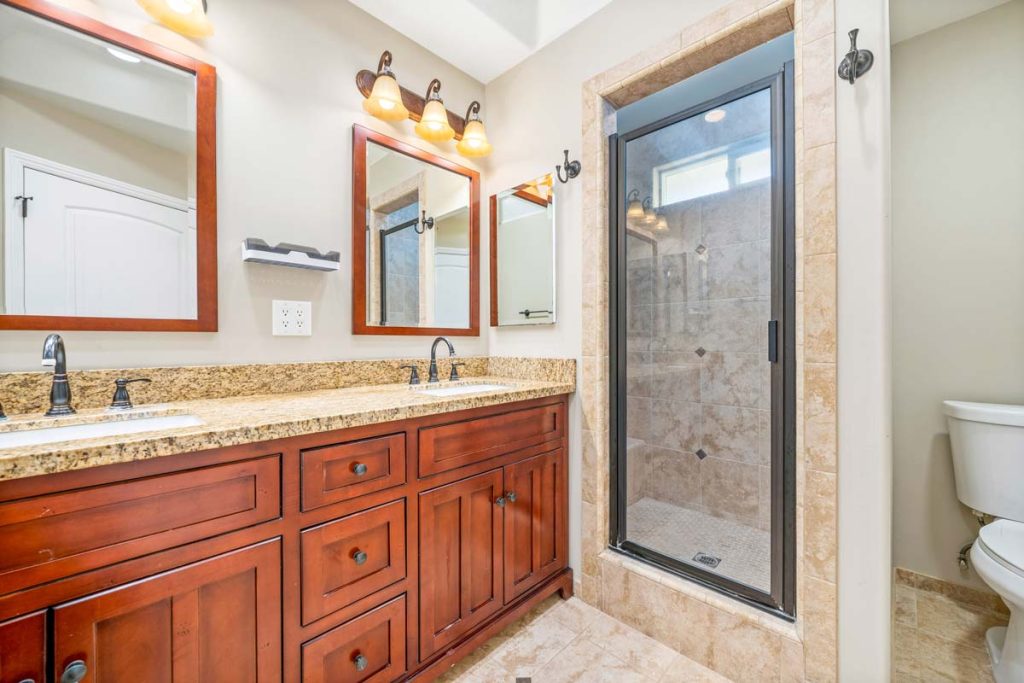 master bathroom with double vanity and walk in shower