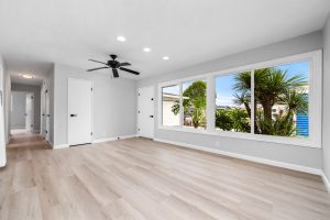 empty home with updated plank style flooring and large window overlooking the front entry