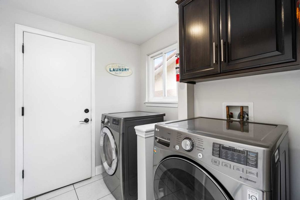laundry room with washer and dryer and cabinets