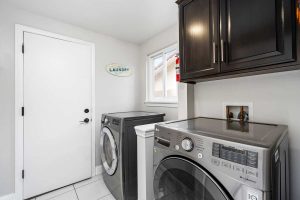 laundry room with washer and dryer and cabinets