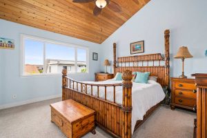 bedroom with wood plank vaulted ceiling