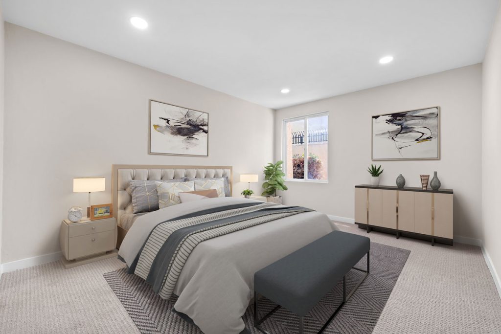 staged master bedroom with bed, night stands, dresser, and artwork on the walls