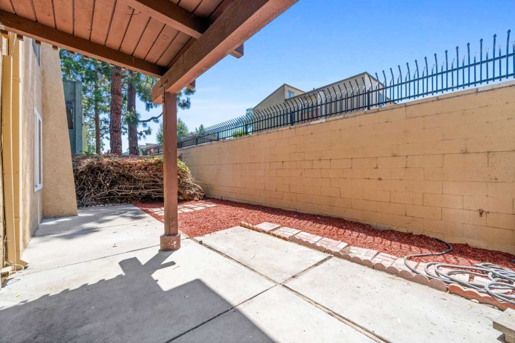 private patio with brick wall