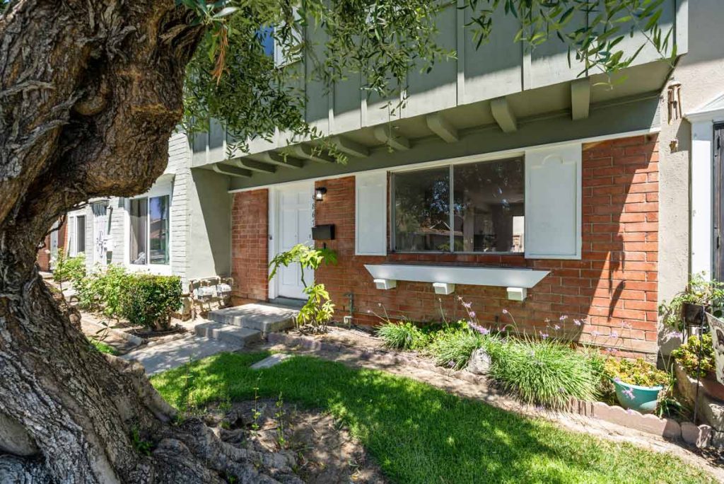 exterior of 9867 Continental Drive, Huntington Beach showing red brick, and cream and olive colored trim