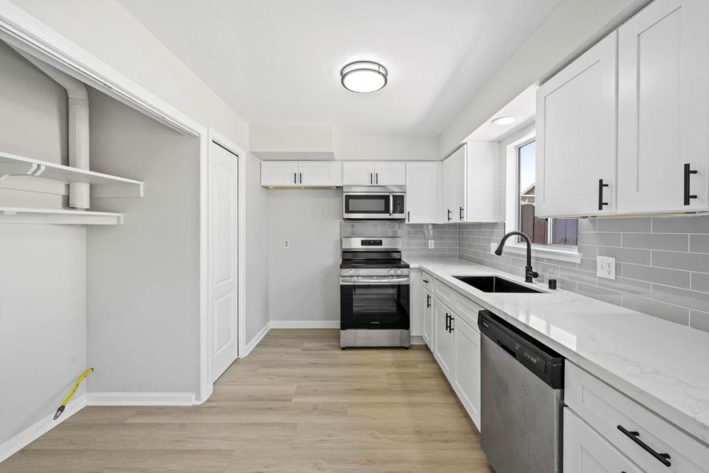 updated kitchen with stainless appliances and white cabinets