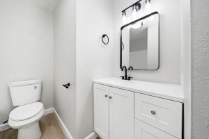 updated bathroom with white cabinets and matte black finishes