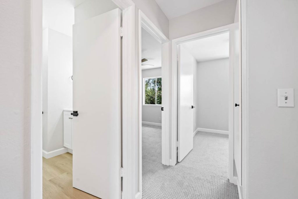 upstairs hall showing doors to bathroom and two bedrooms