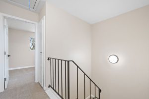 upstairs landing showing carpeted hall and bedroom entrance