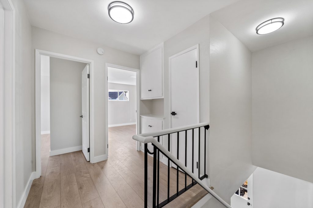 upstairs landing with new painted neutral colored walls and hardwood flooring