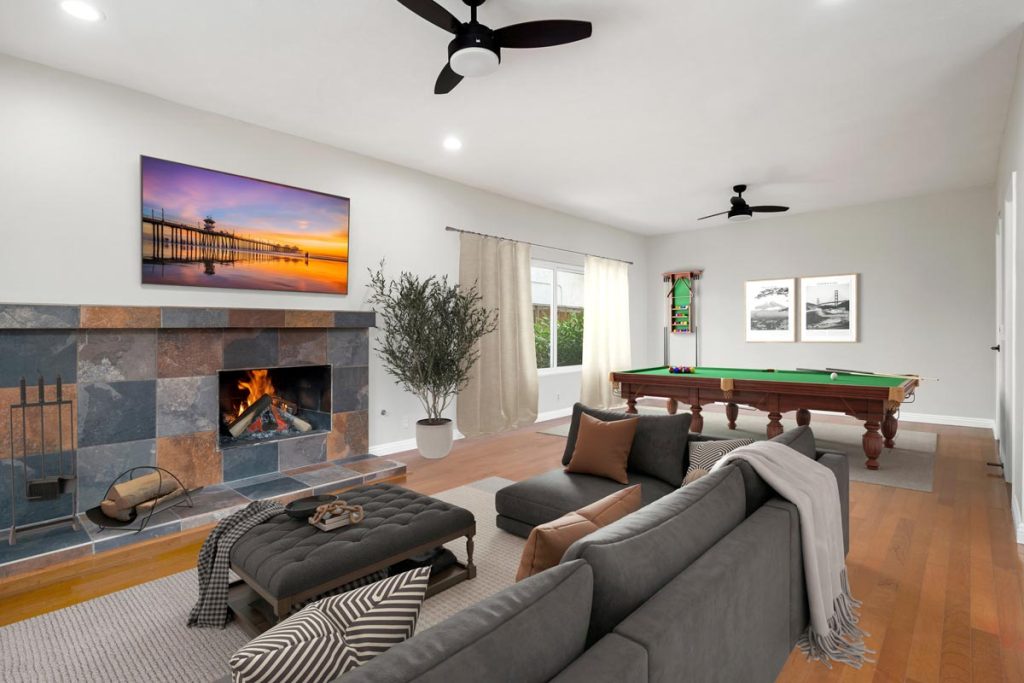 living room with fireplace, couch and pool table in the background