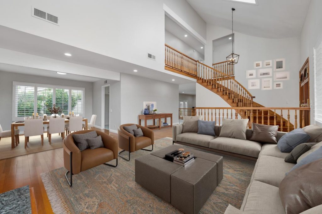 staged picture of family room with dining room and staircase in background