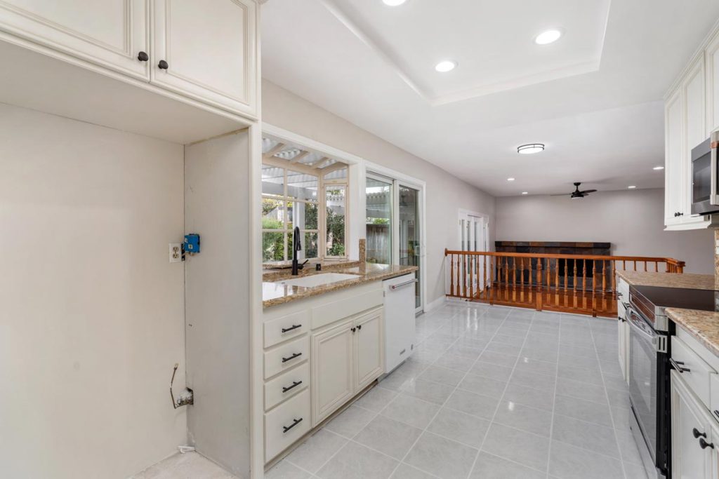 empty kitchen, eat-in area, and living room in the background